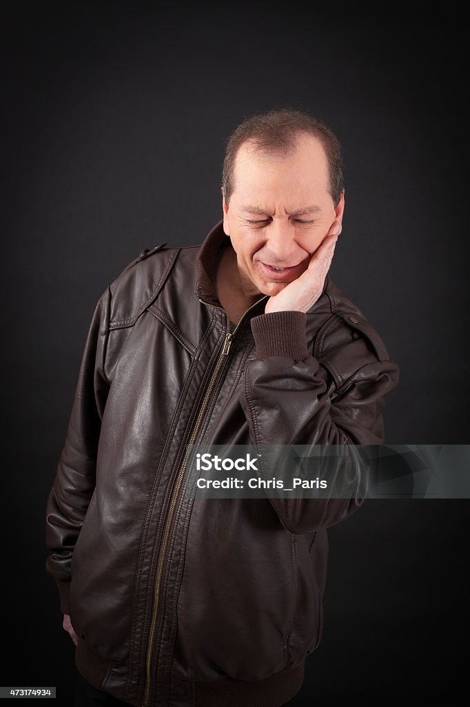 Handsome man doing different expressions in different sets of clothes Handsome man doing different expressions in different sets of clothes: toothache 2015 Stock Photo