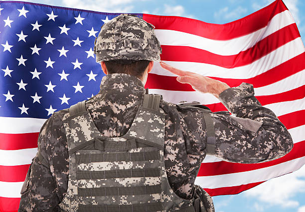 istock Soldier Saluting American Flag 473175396