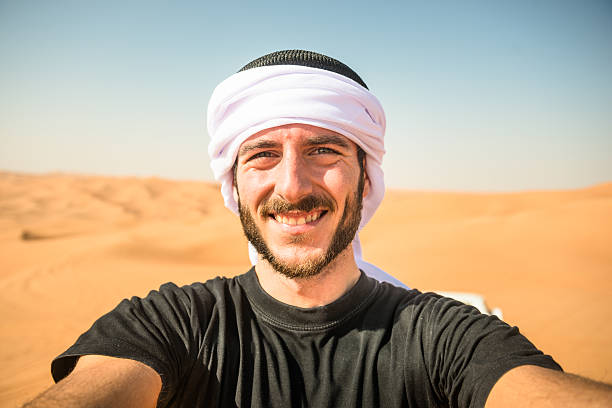 istock tourist man doing a selfie on the desert 473176078