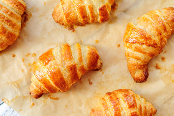 istock Fresh baked croissants on baking paper 473180538