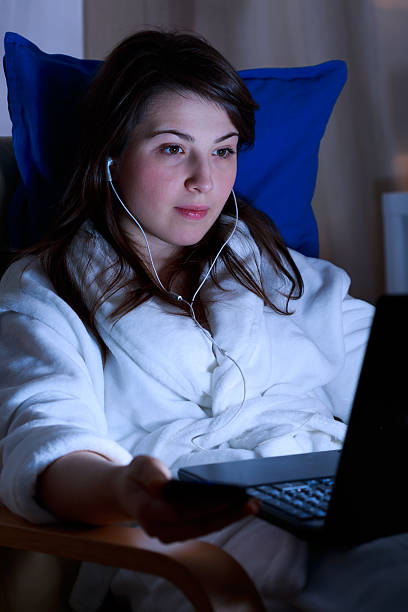 istock Girl with headphones using laptop 473180926