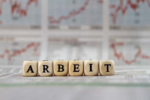 istock Work written with letter cubes on a newspaper 473185180