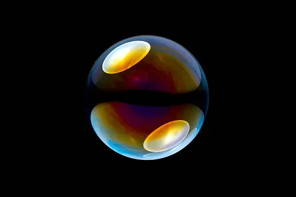 single colorful soap bubble against black background