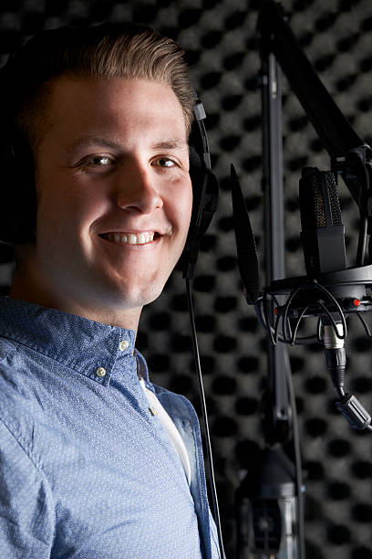 istock Man In Recording Studio Talking Into Microphone 473188592