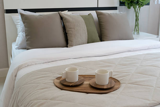 istock Decorative wooden tray with tea set on bed 473189042