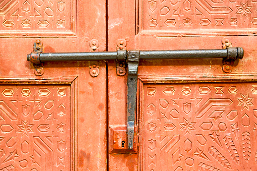 Close-up view of old wooden closed front door , cast iron gate,  jewish symbols, jewish quater.  Ribadavia, Ourense province, Galicia, Spain.