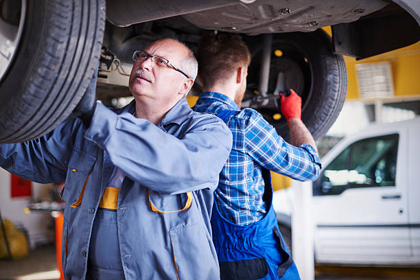 istock Screwing tires by two mechanics 473190676
