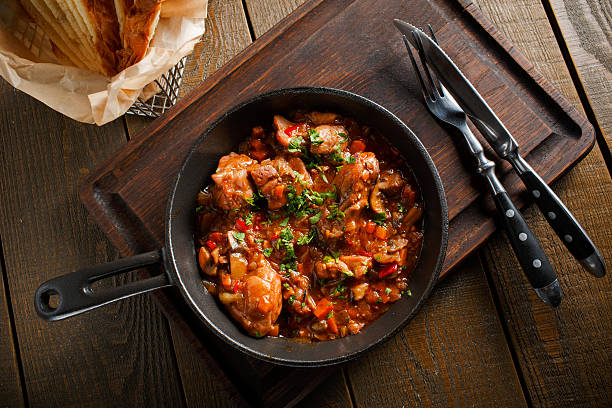 istock Fried meat in a frying pan tomato sauce 473190890