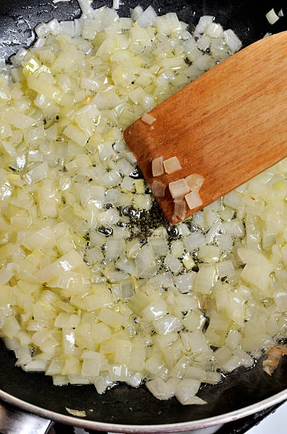 istock Sliced onions fried in oil 473191336