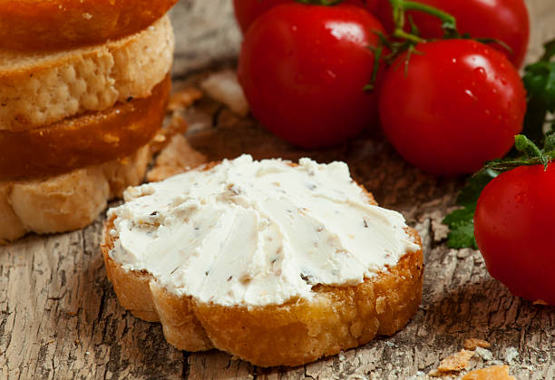 istock Home crostini with soft cheese and tomatoes on wooden table 473193608