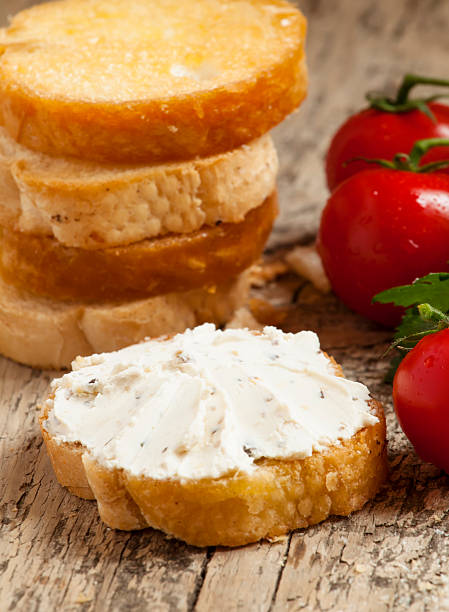 istock Home crostini with soft cheese and tomatoes on wooden table 473194310