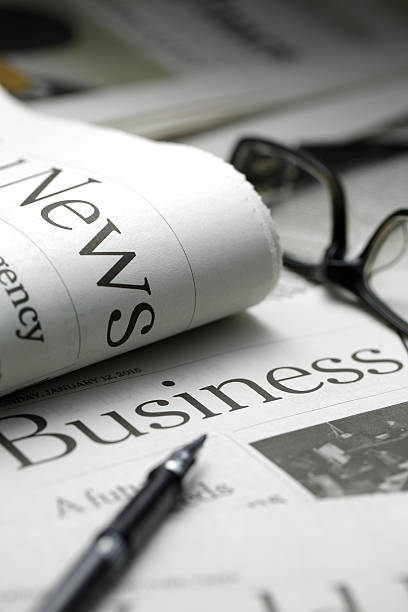 istock Glasses on newspaper and black pen. 473195146