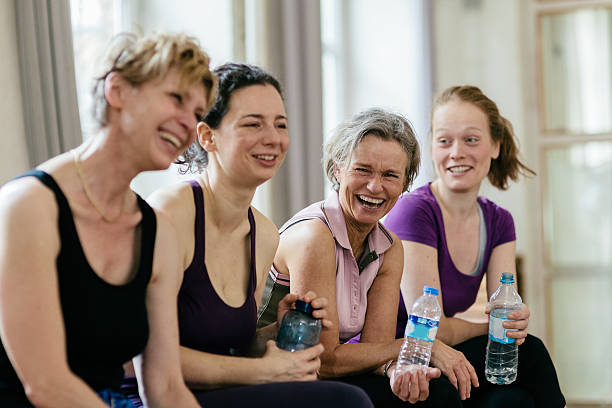 mulheres felizes segurando garrafas de água na academia de ginástica - water bottle sports and fitness selective focus sport - fotografias e filmes do acervo