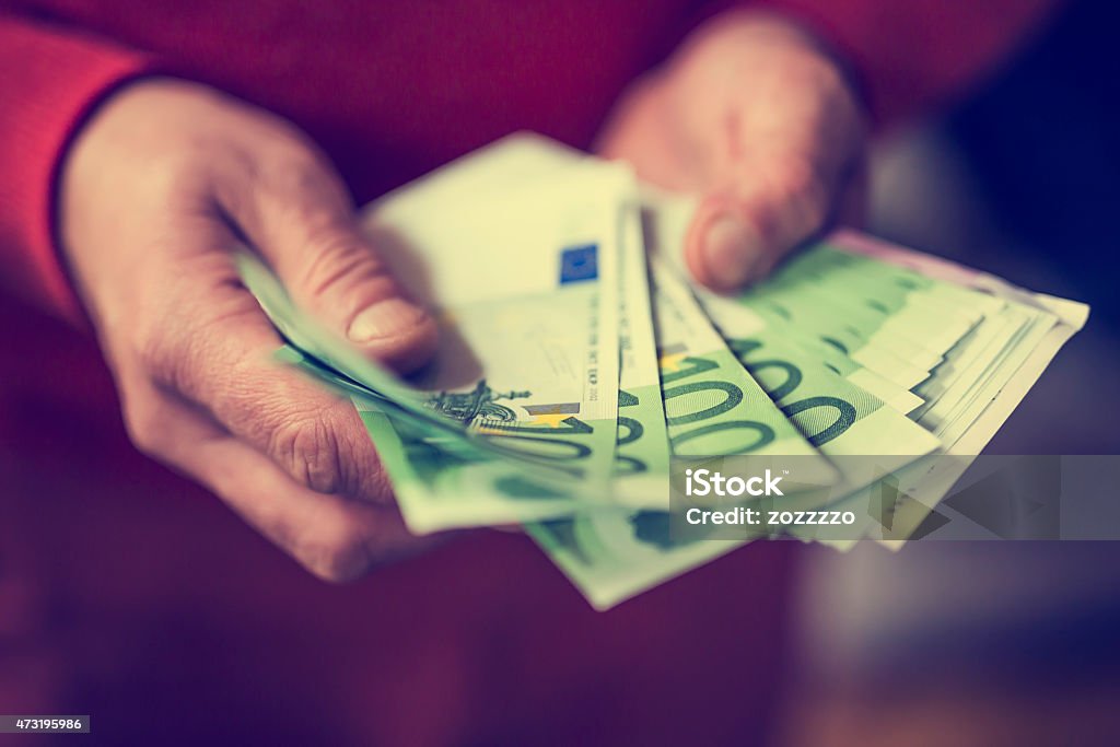 Euros in hand Man counting the money, 100 euros banknotes in hand 2015 Stock Photo