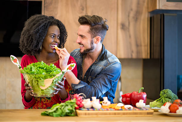 istock Man feeding woman in the kitchen 473196456