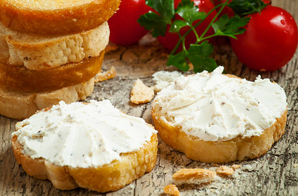 istock Home crostini with soft cheese and tomatoes on wooden table 473204582