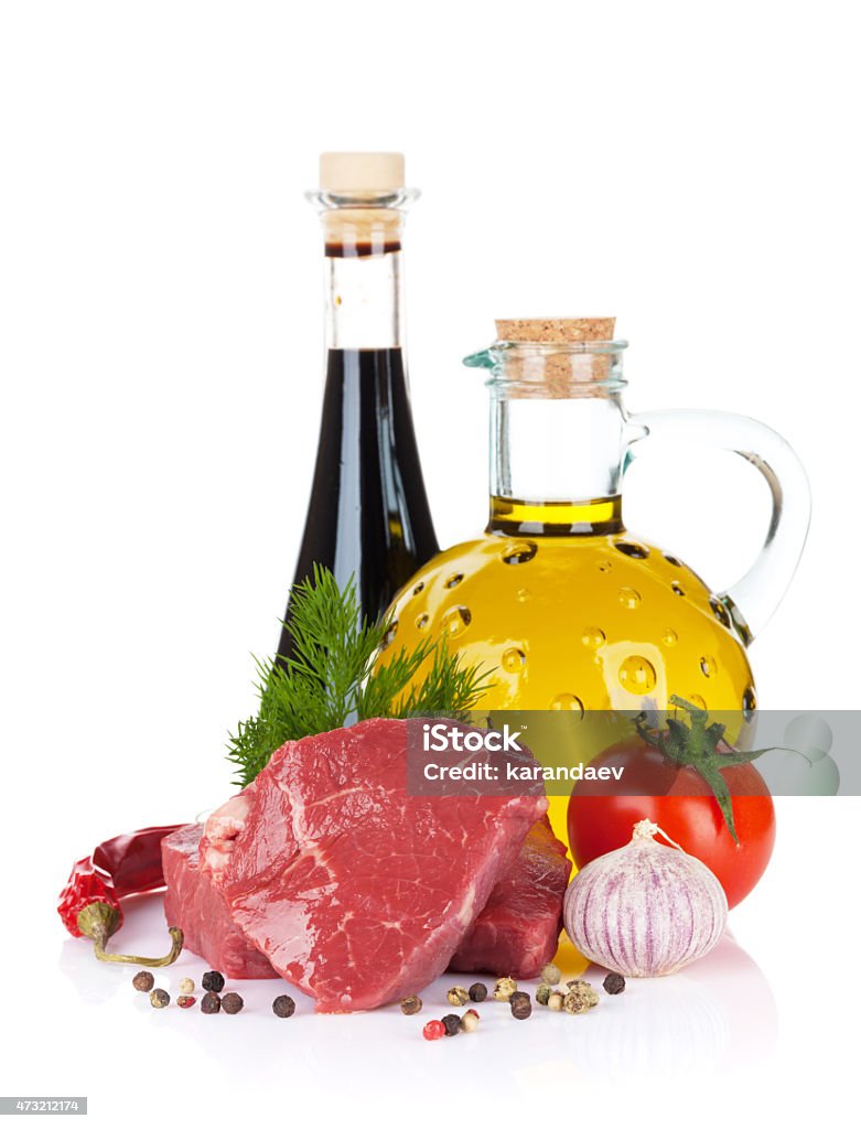 Raw fillet beef steak and spices Raw fillet beef steak and spices. Isolated on white background 2015 Stock Photo