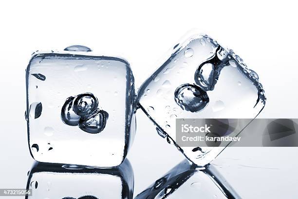 Two Melting Ice Cubes With Water Dew Stock Photo - Download Image Now - 2015, Block Shape, Blue