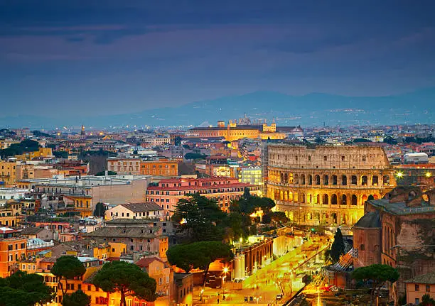 Colosseum in Rome after sunse with citylights