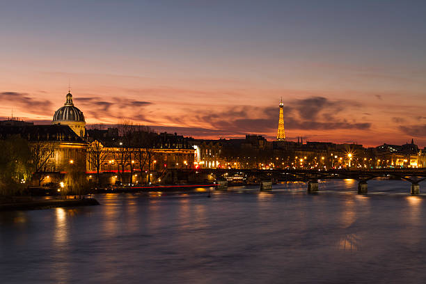 Ecole Nationale Superieure During Sunset View of Paris as seen from the Pont Neuf. Visible are the Tour Eiffel and the École nationale supérieure des beaux-arts de Paris together with the Pont des Arts. ecole stock pictures, royalty-free photos & images