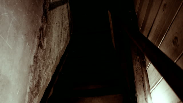 Walking down the spooky stairs in a haunted house.