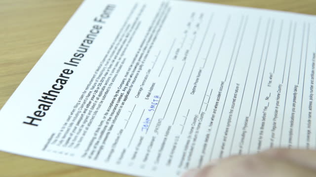 CNGLMED545 - People filling out generic healthcare insurance forms.
