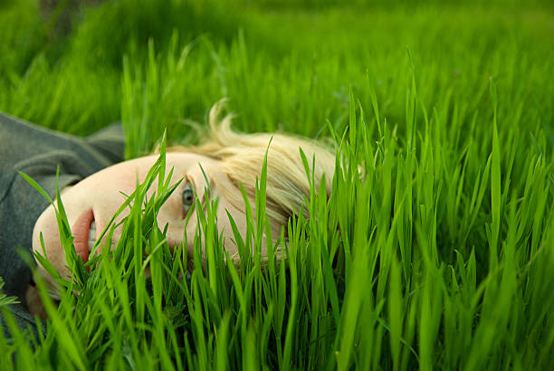 istock girl's head in the grass 473229886