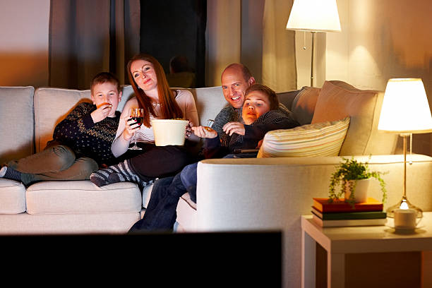 istock Family watching television at evening 473233836