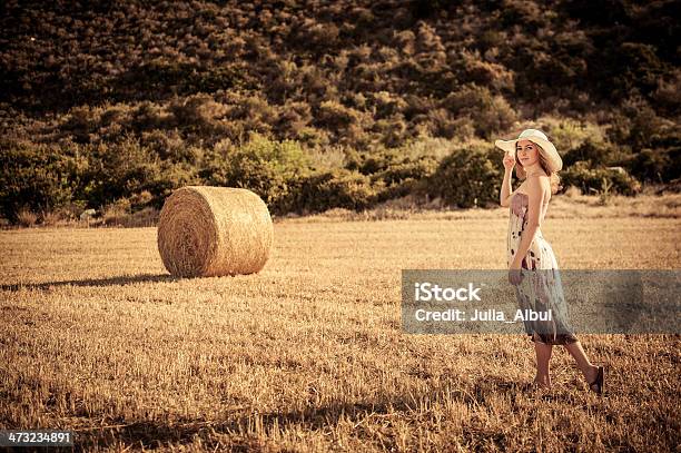 Young Woman Is Walking Through The Harvest Field Stock Photo - Download Image Now - Adult, Adults Only, Agricultural Field