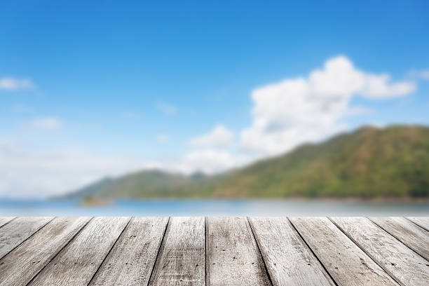 istock Wood planks floor with blurry Scenic landscape 473236576