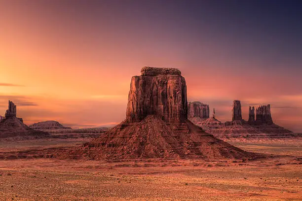 Ethereal clouds over red rock butte at dusk in Monument Valley, Arizona