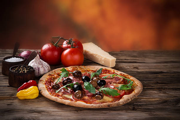 istock Delicious italian pizza served on wooden table 473243354