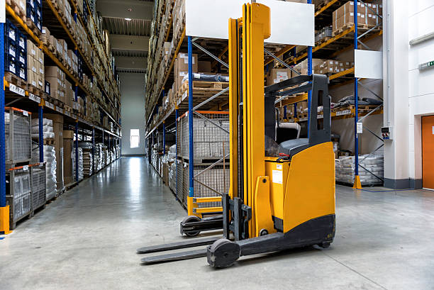 Yellow fork lift stopped in a warehouse stock photo
