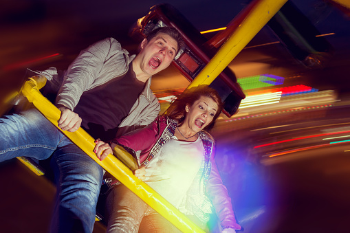 Beautiful, young couple having fun at an amusement park