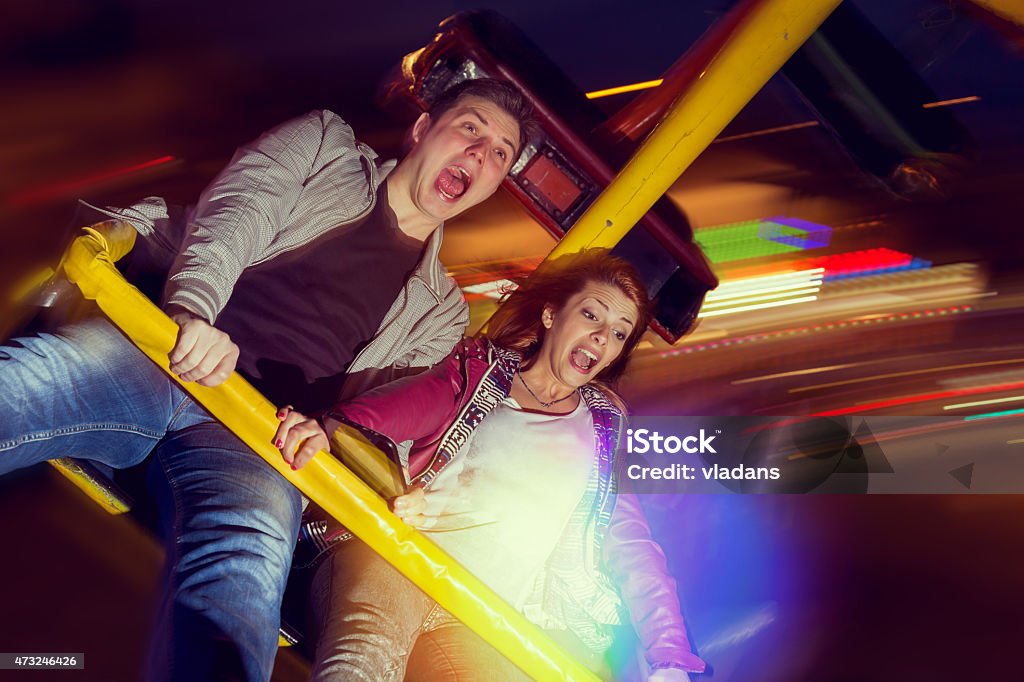 Fear Beautiful, young couple having fun at an amusement park Laughing Stock Photo