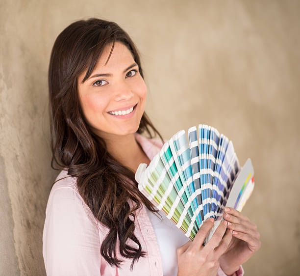 istock Woman painting her house 473246686