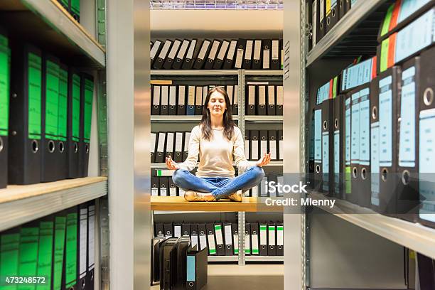 Woman Meditating In Company Finance File Archive Stock Photo - Download Image Now - Archives, File Folder, Business