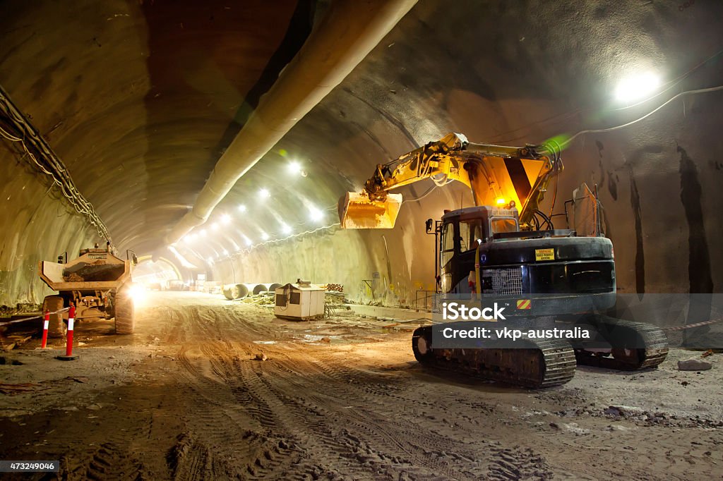 Concrete Road Tunnel Construction Excavator Concrete Road Tunnel Construction Excavator and Articulated Dump Truck Construction Industry Stock Photo