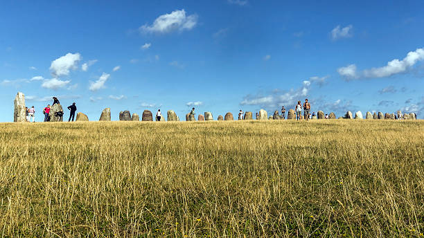 Ales Stenar Kasaberga, Sweden - August 14, 2014: Tourists visit area of Ales Stenar, mysterious circle created 1400 years ago. The circle consists of 59 large stones forming a circle resembling a ship shape. ales stenar stock pictures, royalty-free photos & images
