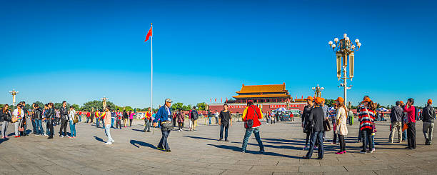 Beijing Tiananmen Square Chinese tourists crowds Forbidden City panorama China Beijing, China - 25th September 2013: Groups of tourists sight seeing in Tiananmen Square, the popular landmark outside the Forbidden City in the heart of Beijing, China's vibrant capital city. Composite panoramic image created from nine contemporaneous sequential photographs. forbidden city beijing architecture chinese ethnicity stock pictures, royalty-free photos & images
