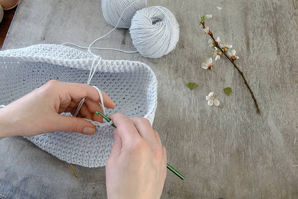 istock hand crochet and blue threads on wooden table 473256428