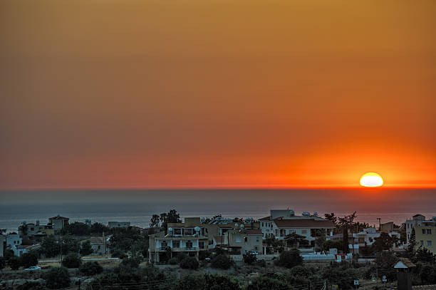 istock Sunset over village on sea coast 473259334
