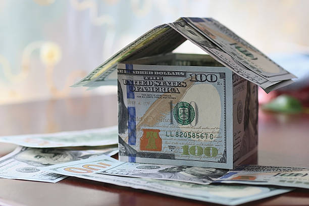 istock Real Estate dollar house background 473264122