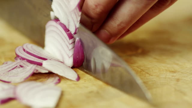 Professional Cook Rapidly Chopping Onion, Close-Up