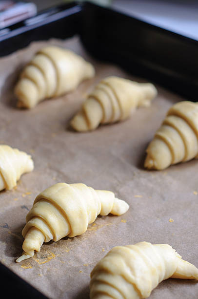 istock Not baked croissants on oven-tray 473265576