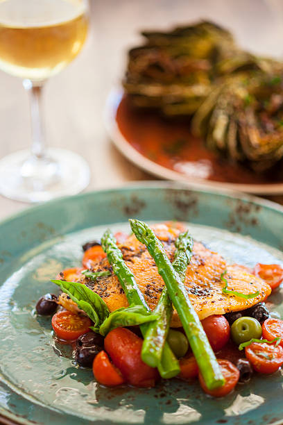 istock organic Arctic char fish on a bed of roasted tomatoes 473265924
