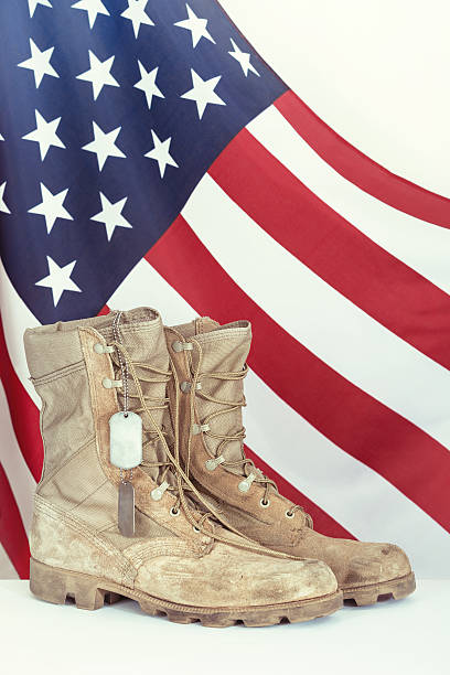 istock Old combat boots and dog tags with American flag 473269156