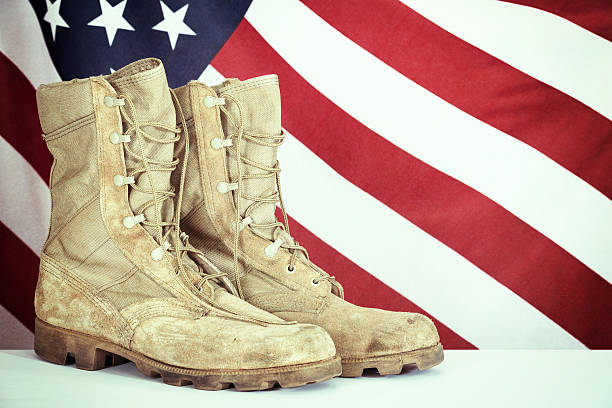 istock Old combat boots with American flag 473269158
