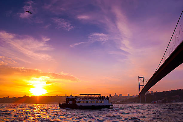 istock Bosphorus Bridge and excursion boat at sunset, Istanbul, Turkey. 473272114