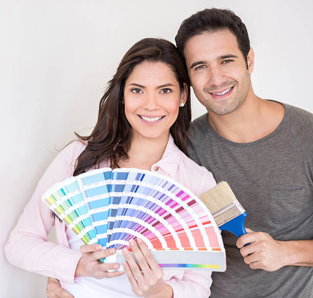 istock Couple painting their house 473283840